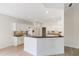 Open-concept kitchen features an island with granite countertop, providing ample space for food prep and entertaining at 2561 Grapevine Cir # 104, Cumming, GA 30041