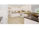 Modern kitchen boasts white cabinets, dark countertops, stainless steel appliances, and tile backsplash at 2561 Grapevine Cir # 104, Cumming, GA 30041