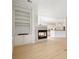 Open-concept living area featuring a fireplace, built-in shelving, and an adjacent modern kitchen at 2561 Grapevine Cir # 104, Cumming, GA 30041