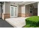 Exterior patio with manicured landscaping, brick accents, and a welcoming entrance at 2561 Grapevine Cir # 104, Cumming, GA 30041