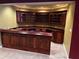 Gorgeous wooden wet bar with glass and wood cabinetry, sink, and plenty of counter space at 3360 Keenland Rd, Marietta, GA 30062