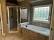 This primary bathroom features a soaking tub, glass shower, and lovely tile surround at 3360 Keenland Rd, Marietta, GA 30062