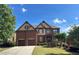 Charming two-story brick home featuring a well-manicured lawn and attached two-car garage at 3360 Keenland Rd, Marietta, GA 30062
