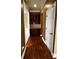Hallway featuring hardwood floors, built-in cabinets with granite countertop, and access to additional rooms at 3360 Keenland Rd, Marietta, GA 30062