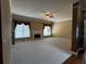 Bright living room featuring a fireplace, neutral carpet, fan, and large windows for ample natural light at 3360 Keenland Rd, Marietta, GA 30062