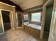 Primary bath features a soaking tub, a walk-in shower, and decorative windows at 3360 Keenland Rd, Marietta, GA 30062