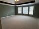 Large primary bedroom boasts tray ceilings, ample windows, and plush carpeting at 3360 Keenland Rd, Marietta, GA 30062