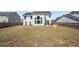 Spacious backyard enclosed by a wooden fence with a large home and several trees at 4607 Underwood Walk, Powder Springs, GA 30127