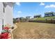 Spacious backyard, enclosed by a wooden fence with some flowering plants and lush green grass at 4607 Underwood Walk, Powder Springs, GA 30127
