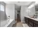 Bright bathroom with double vanity, soaking tub, and walk-in closet at 4607 Underwood Walk, Powder Springs, GA 30127
