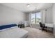 This bedroom features a bed, crib, and a desk near a window allowing natural light in at 4607 Underwood Walk, Powder Springs, GA 30127