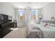 Bedroom features two windows for natural light, a dresser, and a bed with floral bedding at 4607 Underwood Walk, Powder Springs, GA 30127