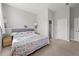 Bedroom features a bed with floral bedding, a door to the ensuite, and dual closets at 4607 Underwood Walk, Powder Springs, GA 30127
