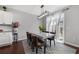 Bright dining room features modern lighting fixture, hardwood floors, and sliding doors to the backyard at 4607 Underwood Walk, Powder Springs, GA 30127