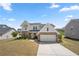 Attractive two-story home featuring brick and white siding, a well-kept front yard, and an attached two-car garage at 4607 Underwood Walk, Powder Springs, GA 30127