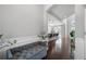 Inviting foyer with hardwood floors, a bench, and views into the open-concept kitchen and living spaces at 4607 Underwood Walk, Powder Springs, GA 30127