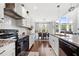 Well-equipped kitchen with granite countertops, white cabinets, stainless steel appliances, and an eat-in dining area at 4607 Underwood Walk, Powder Springs, GA 30127