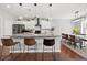 Bright kitchen featuring a large island with seating, modern appliances, and an adjacent dining area for entertaining at 4607 Underwood Walk, Powder Springs, GA 30127