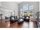 Open concept living room with hardwood floors, high ceilings, and a view to the dining area at 4607 Underwood Walk, Powder Springs, GA 30127