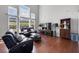 Sunlit living room with high ceilings, hardwood floors, and large windows overlooking the backyard at 4607 Underwood Walk, Powder Springs, GA 30127