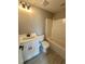 A bathroom with a white vanity, toilet, shower, and light gray tile floor at 1111 Lake Varner Dr, Covington, GA 30014