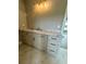 Bathroom features a light gray cabinet, light countertop, and gold hardware at 1111 Lake Varner Dr, Covington, GA 30014