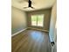 Bright bedroom with neutral walls, ceiling fan, and wood flooring at 1111 Lake Varner Dr, Covington, GA 30014