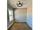 Bright bedroom with hardwood flooring, neutral-toned walls and a modern light fixture at 1111 Lake Varner Dr, Covington, GA 30014