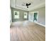 Spacious bedroom with tray ceiling, ceiling fan, light gray walls, and hardwood floors at 1111 Lake Varner Dr, Covington, GA 30014