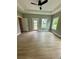 Bright bedroom with hardwood floors, tray ceiling, ceiling fan, and natural light from multiple windows at 1111 Lake Varner Dr, Covington, GA 30014