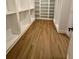 A view of the closet with wood floor and white storage shelves at 1111 Lake Varner Dr, Covington, GA 30014