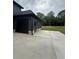 Spacious two-car garage features stone detail, carriage door, and ample parking at 1111 Lake Varner Dr, Covington, GA 30014