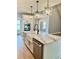Modern kitchen island with a farmhouse sink and marble counter tops at 1111 Lake Varner Dr, Covington, GA 30014