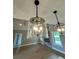 Living room with a stone fireplace and unique pendant lights and hardwood floors at 1111 Lake Varner Dr, Covington, GA 30014