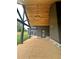 Covered patio features stained wood ceiling, stylish lights, and gray-stained concrete at 1111 Lake Varner Dr, Covington, GA 30014
