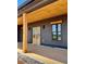 Covered porch features wood ceiling, stone base, and a stylish double-door entry at 1111 Lake Varner Dr, Covington, GA 30014