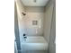 Bathroom features a tiled shower with a niche and modern black fixtures at 1111 Lake Varner Dr, Covington, GA 30014