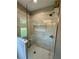 Glass enclosed shower featuring a built-in seat, shower niche, and tiled walls with decorative tile accents at 1111 Lake Varner Dr, Covington, GA 30014