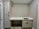 Laundry room sink and built-in desk with gray cabinets and hardware at 1111 Lake Varner Dr, Covington, GA 30014