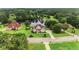 Aerial shot of the home in a community with a lake and mature trees offering scenic views at 127 Courts Of Hampton, Hampton, GA 30228