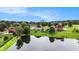 Aerial view showcases the home's lakefront community surrounded by lush landscaping at 127 Courts Of Hampton, Hampton, GA 30228