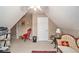 Finished attic space with sloped ceilings, neutral paint, and vintage furnishings at 127 Courts Of Hampton, Hampton, GA 30228