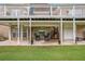 View of the backyard and covered patio with spiral staircase, offering outdoor living at 127 Courts Of Hampton, Hampton, GA 30228