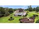 A meticulously landscaped backyard with a covered patio, deck, and manicured lawns at 127 Courts Of Hampton, Hampton, GA 30228