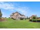 Expansive lawn with mature trees and shrubs create a tranquil outdoor setting at 127 Courts Of Hampton, Hampton, GA 30228