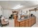 Finished basement bar area with wood cabinets, sink, and seating area at 127 Courts Of Hampton, Hampton, GA 30228
