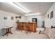 Basement bar area with wooden counter, bar stools, and neutral carpet at 127 Courts Of Hampton, Hampton, GA 30228