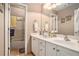 Bright bathroom with a double vanity, white cabinets, and a glass-enclosed shower at 127 Courts Of Hampton, Hampton, GA 30228