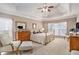Bright bedroom with tray ceiling, neutral paint, and a brass bed dressed in white and gold linens at 127 Courts Of Hampton, Hampton, GA 30228