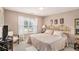 Bedroom featuring a large window, gold metal bed frame, carpet floor and side table with a lamp at 127 Courts Of Hampton, Hampton, GA 30228
